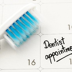 Toothbrush and dental appointment on calendar