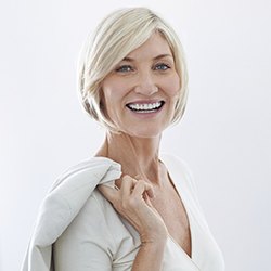 A middle-aged woman looking into the camera against a white background