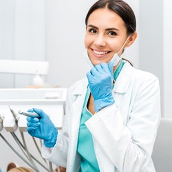 A smiling dentist working with her patient