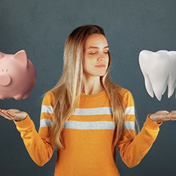 Person weighing between a piggy bank and a tooth