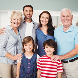 Three generations of smiling family members