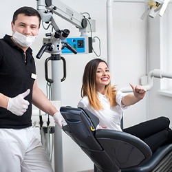 Dentist and patient giving thumbs up
