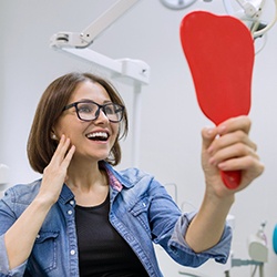 young woman admiring her new dental implants in Lisle