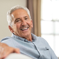 Older man with dentures smiling