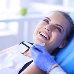 Woman smiling at her emergency dentist in Lisle