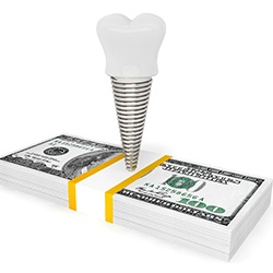 Dental implant on a stack of money