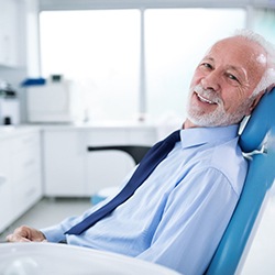 Senior man in light blue shirt and tie at dentist’s office