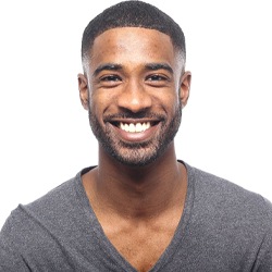 Man smiling after receiving an onlay.