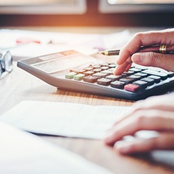 Person sitting at a desk doing calculations