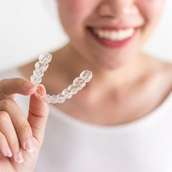 person holing an aligner for Invisalign in Lisle 
