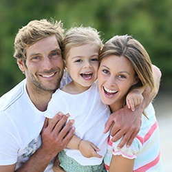 Smiling mother father and child outdoors