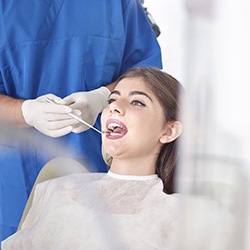 Woman receiving oral cancer screening