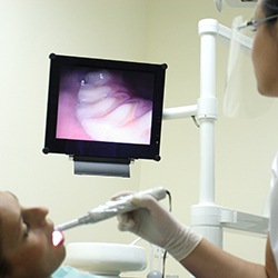 Dentist and patient looking at intraoral photos