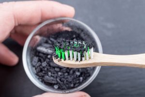 Toothbrush dipped in charcoal