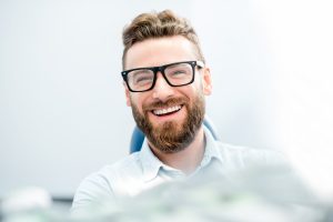 blonde head man in glasses smiling