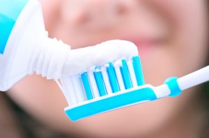 Toothpaste being put on a toothbrush