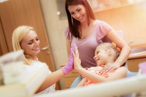 a mother and daughter at the dentist office