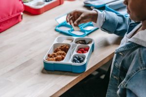 Young boy eating lunch at school