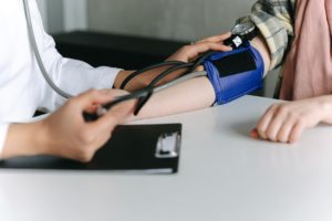 Physician checking blood pressure