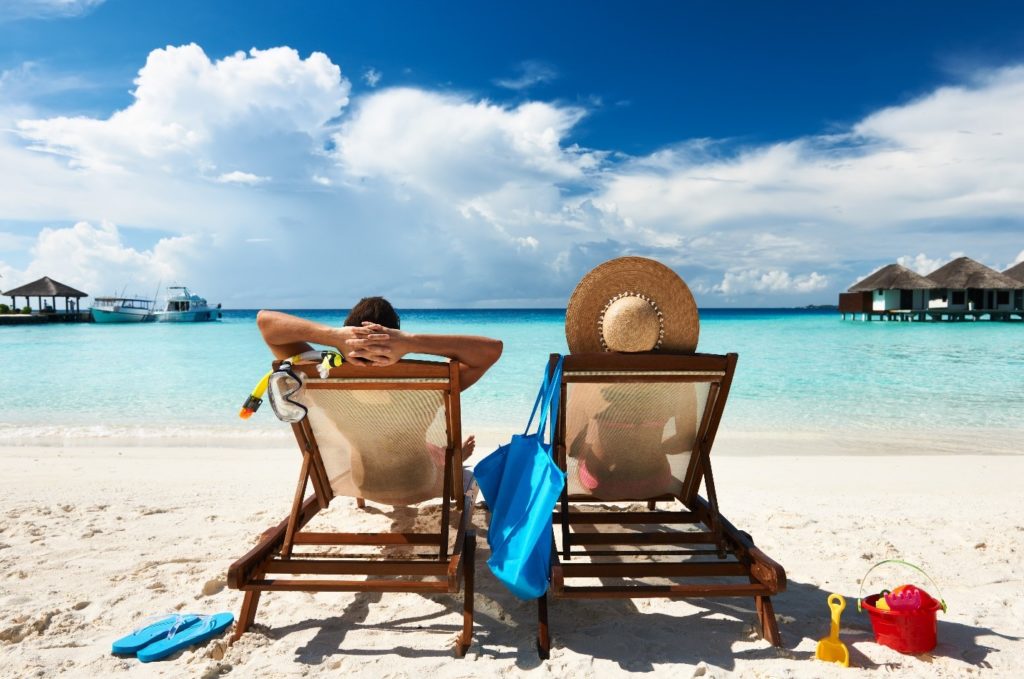 people relaxing on beach 