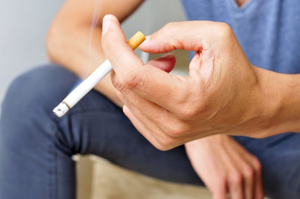 closeup of person holding a cigarette