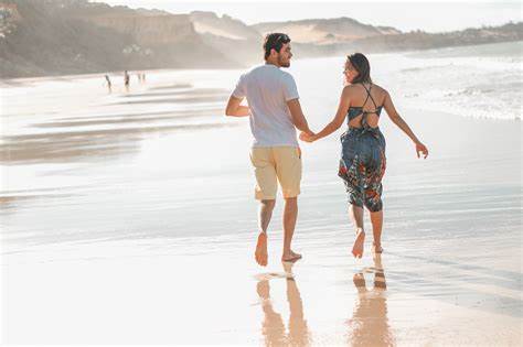 person dating with Invisalign on date walking on beach