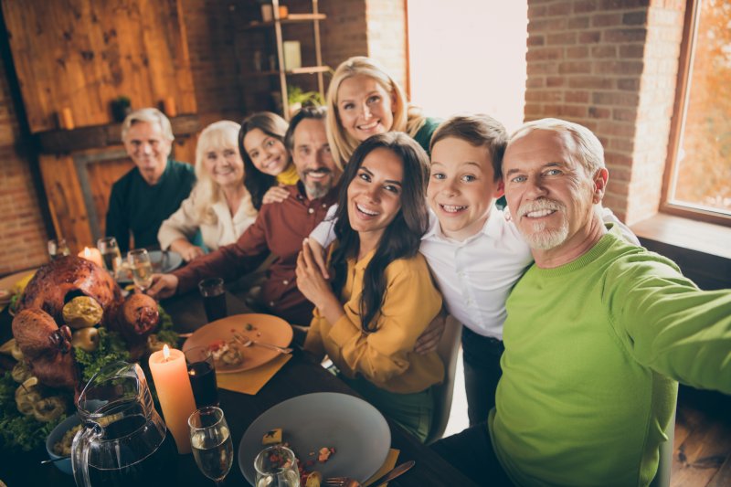 A family enjoying Thanksgiving food after teeth whitening treatment