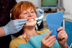 Woman at dentist to reline her dentures