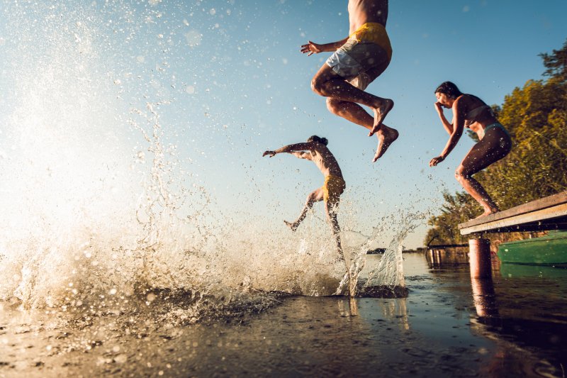 Kids jump in swimming hole