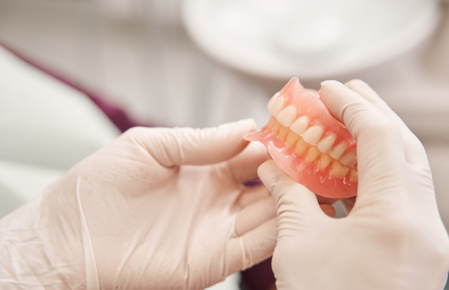 Dentist holding dentures